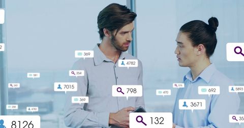 Coworkers Discussing Reports with Overlay of Social Media Analytics
