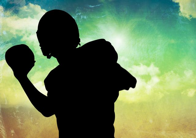 Image depicts silhouette of an American football player in mid-throw against colorful sky with clouds and sunlit background. Useful for sports promotions, motivation concepts, athletic merchandise, and inspirational posters.