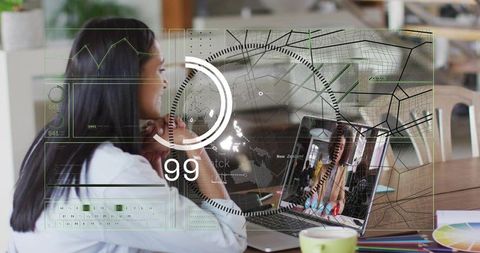 Working Woman Using Laptop with Futuristic HUD Overlay and Color Swatches in Cafe Workspace