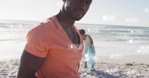 Man standing on sunny beach with social media notification overlays, couple walking