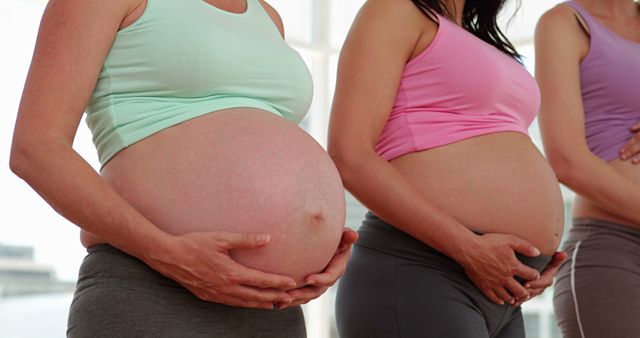 Pregnant Women Holding Bellies During Group Exercise - Download Free Stock Images Pikwizard.com