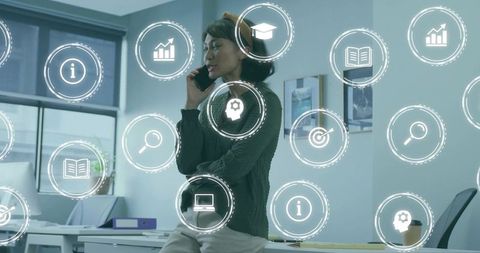 Asian woman talking on phone in modern office with holographic business icons overlay