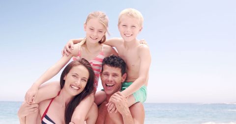 Joyful Family Playing Piggyback on Sunny Beach Day - Download Free Stock Images Pikwizard.com