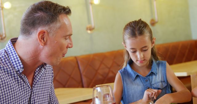 Father Bonding with Daughter at Restaurant Table - Download Free Stock Images Pikwizard.com