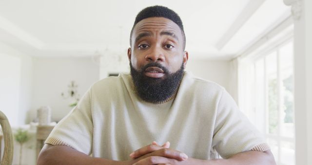 Portrait of Confident Man with Beard Sitting Indoors - Download Free Stock Images Pikwizard.com