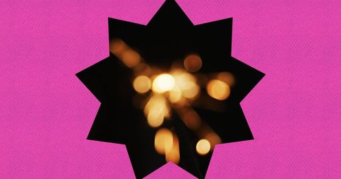 Star-Shaped Frame Encasing Glowing Sparklers on Purple Background