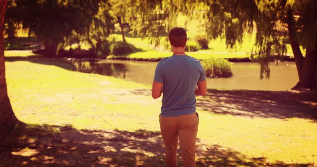 Man Enjoying a Walk in a Sunny Park - Download Free Stock Images Pikwizard.com