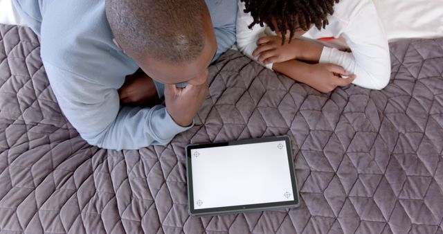 Father and Daughter Watching Digital Tablet on Bed - Download Free Stock Images Pikwizard.com