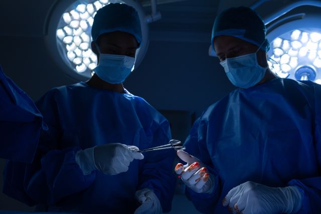 Low angle view of surgeons performing operation in operation theater