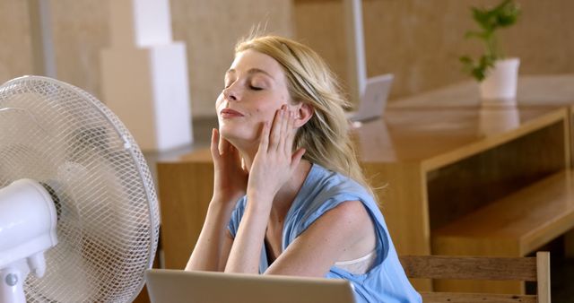 Woman Cooling Down With Fan in Modern Office - Download Free Stock Images Pikwizard.com