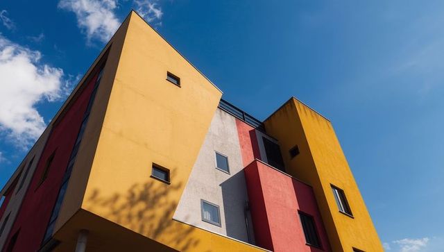 Vibrant urban apartment facade against blue sky