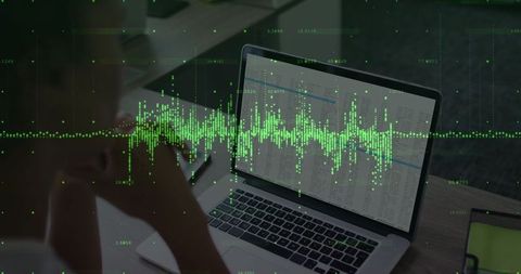 Woman analyzing dynamic data on laptop at modern office workspace
