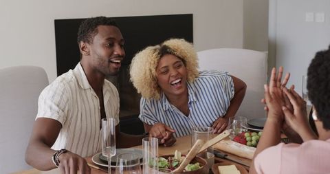 Friends laughing and bonding over casual dining experience