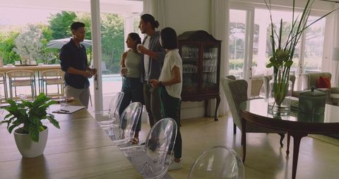 Guests Gathering for Wedding Celebration in Bright Modern Living Room