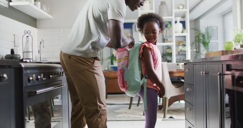 Father and Daughter Engaging in Morning Routine Cooking Together