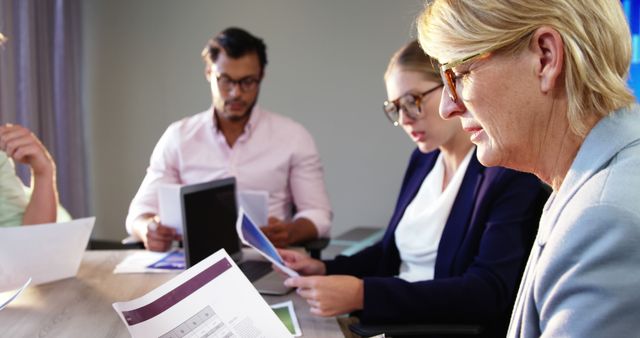 Diverse Team Reviewing Reports in Modern Office Meeting - Download Free Stock Images Pikwizard.com