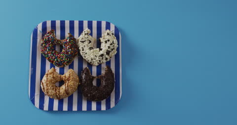 Assorted Donuts with Candy Sprinkles on Striped Plate