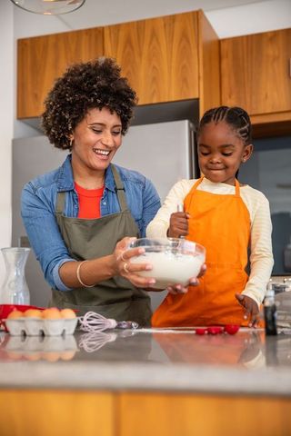 Mother and Daughter Baking with Joy in Modern Kitchen