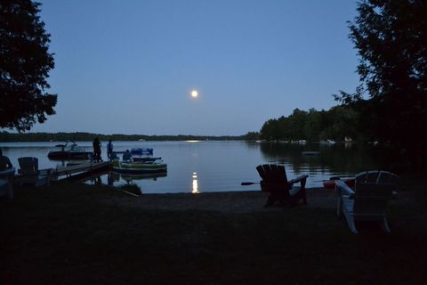 Calm lakeside night with bright moon and boats - Download Free Stock Images Pikwizard.com