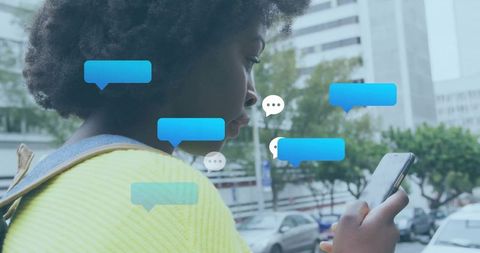 Youthful Woman Engaged With Smartphone in Busy Urban Setting