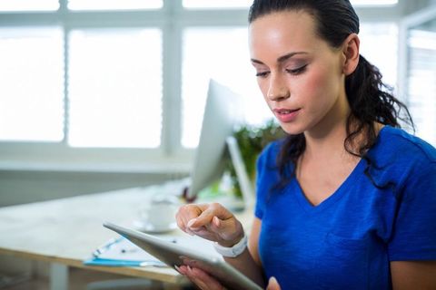 Businesswoman Using Tablet in Bright Office Space