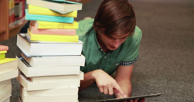 Student Using Tablet While Studying with Books in Library - Download Free Stock Images Pikwizard.com