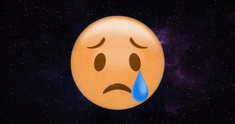 Sad emoji with tear in cosmic space background