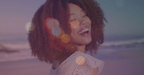 Joyful Woman with Afro Salon Beaming Smile at the Beach