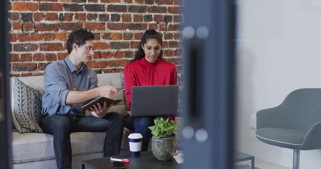 Colleagues Collaborating on Project in Modern Office with Exposed Brick Wall - Download Free Stock Images Pikwizard.com