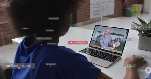 Watching laptop webinar: woman viewing presenter for remote training and virtual coaching