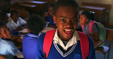 Joyful Student with Backpack in Classroom Setting at School