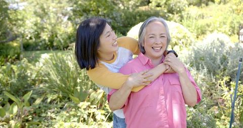 Daughter and Senior Mother Sharing a Warm Embrace Outdoors