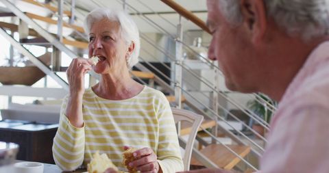 Senior Couple Enjoys Breakfast and Conversation at Home