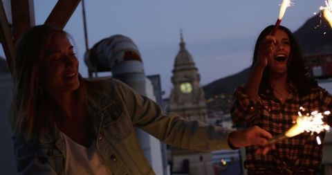 Joyful Friends Celebrating on Rooftop with Sparklers