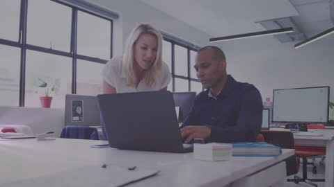 Collaborative Office Environment with Diverse Colleagues Using Laptop