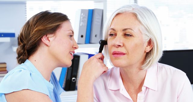 Doctor Examining Senior Woman's Ear in Medical Office - Download Free Stock Images Pikwizard.com