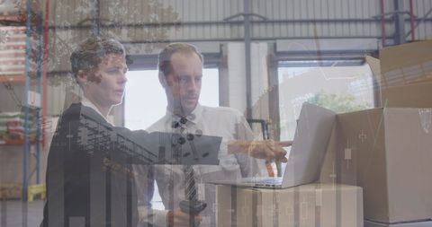 Warehouse managers analyzing financial data