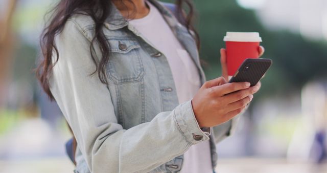 Casual Woman Using Smartphone Outdoors Holding Coffee Cup - Download Free Stock Images Pikwizard.com