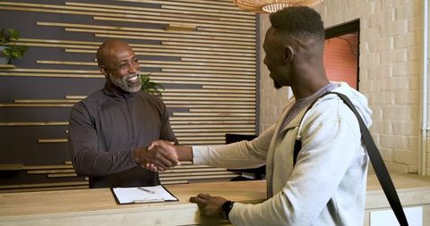 Friendly Welcome at Fitness Center Reception with Handshake