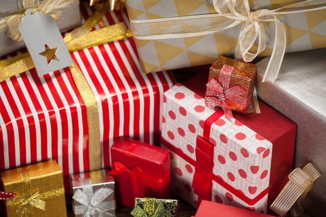 Close-up view of various wrapped gift boxes with colorful ribbons and bows, perfect for holiday and Christmas-themed projects. Ideal for use in advertisements, greeting cards, social media posts, and festive blog articles.