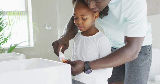 Father teaching daughter to brush teeth in modern bathroom - Download Free Stock Images Pikwizard.com