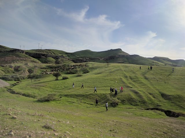 People enjoying outdoor activities on green hillside - Download Free Stock Photos Pikwizard.com
