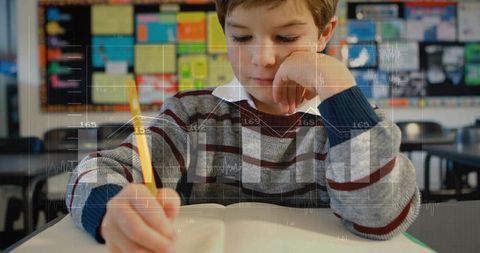 Elementary student writing in classroom with notebook and data overlays showing analytics