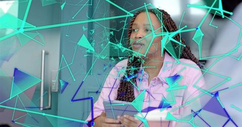 Businesswoman with braided hair tapping tablet with turquoise ar data visuals overlay