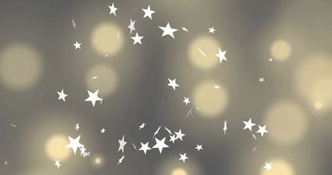 Scattering white stars over warm golden bokeh on grey-beige gradient backdrop