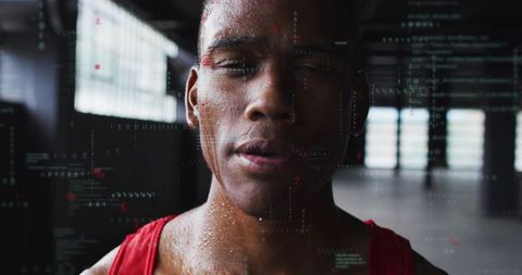 Focused male athlete training with holographic data overlay in industrial warehouse gym