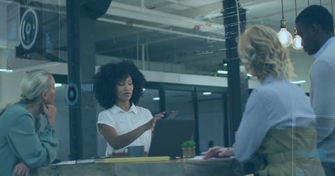 Innovative business team analyzing data with technology overlay