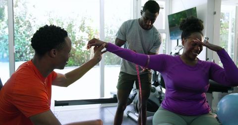 Friends Exercising in Home Gym with Resistance Bands