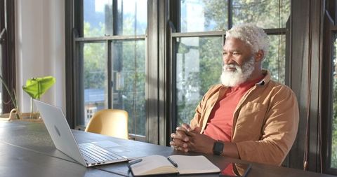 Mature Man Working on Laptop in Home Office
