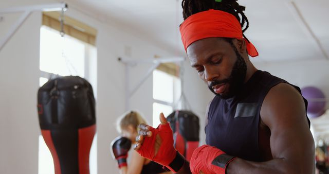 Focused Male Boxer Wrapping Hands in Gym - Download Free Stock Images Pikwizard.com